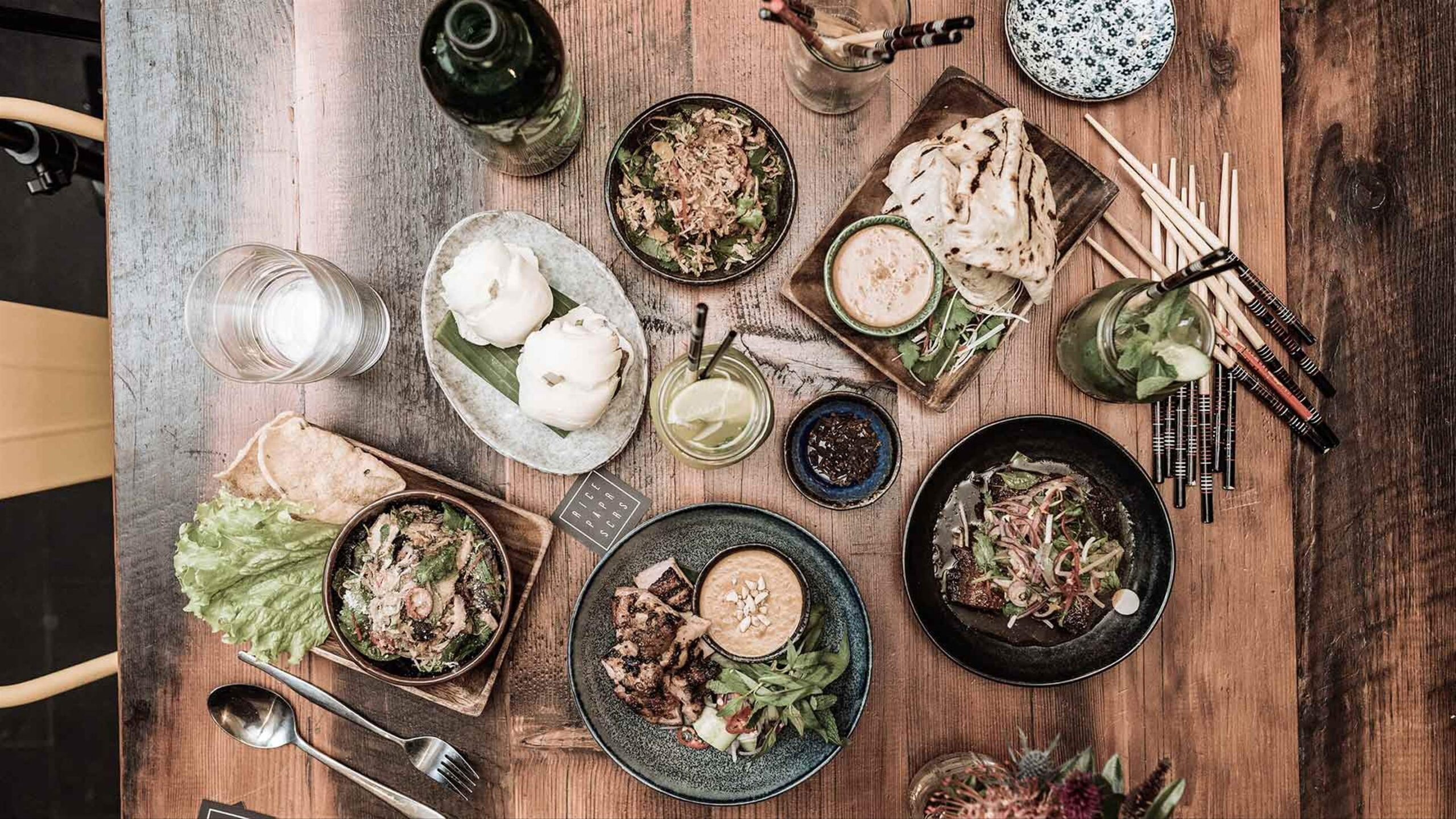 Vietnamese dishes and drinks spread across a shared table